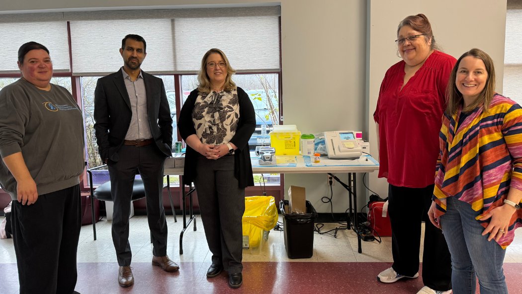 A group of people pose for a photo at a community event.