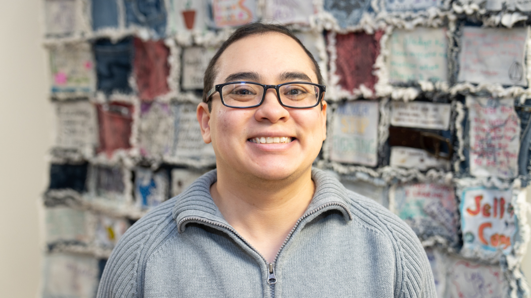 Christopher Keel, patient, in front of the jean quilt at the Adult Eating Disorders Service, LHSC