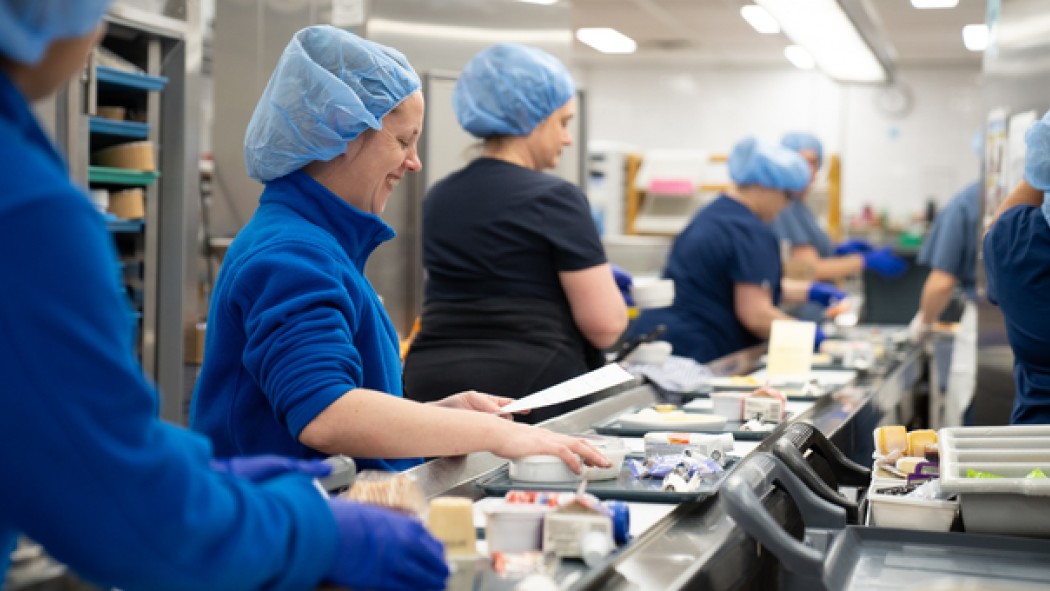 Dietary workers prepare the 945 trays that go out with each meal service