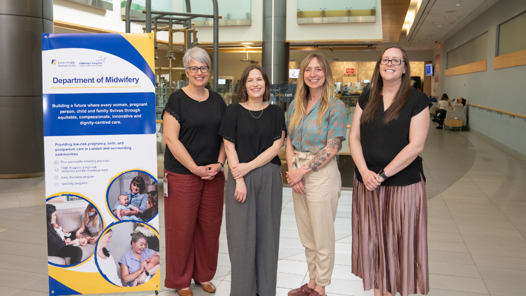 Group of 4 midwives standing in atrium of Victoria Hospital