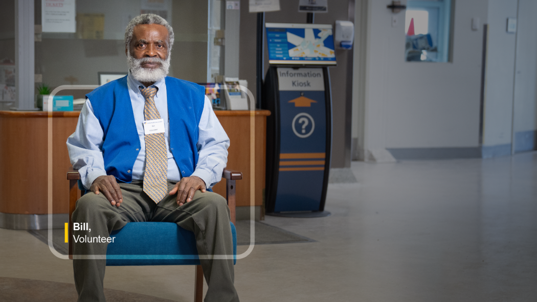 A man sits in a blue chair.