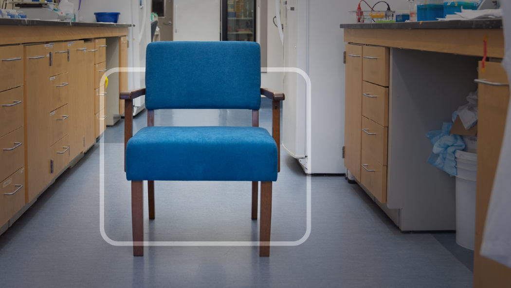 A blue chair stands in the middle of a lab.