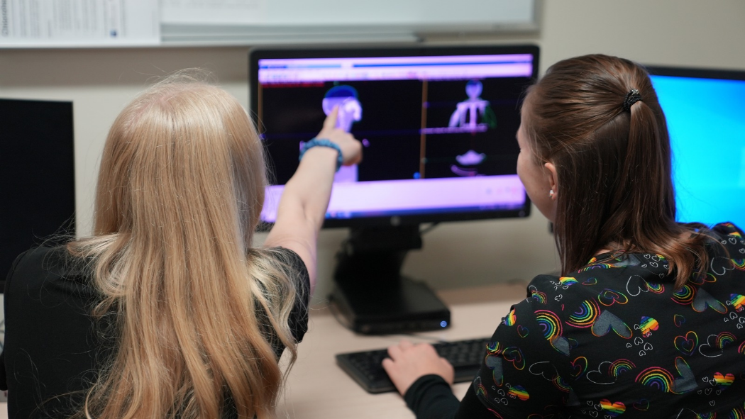 Photo from left: Christine Rossi and Meghan Koczwara, radiation therapists, examining CT simulation scans. 