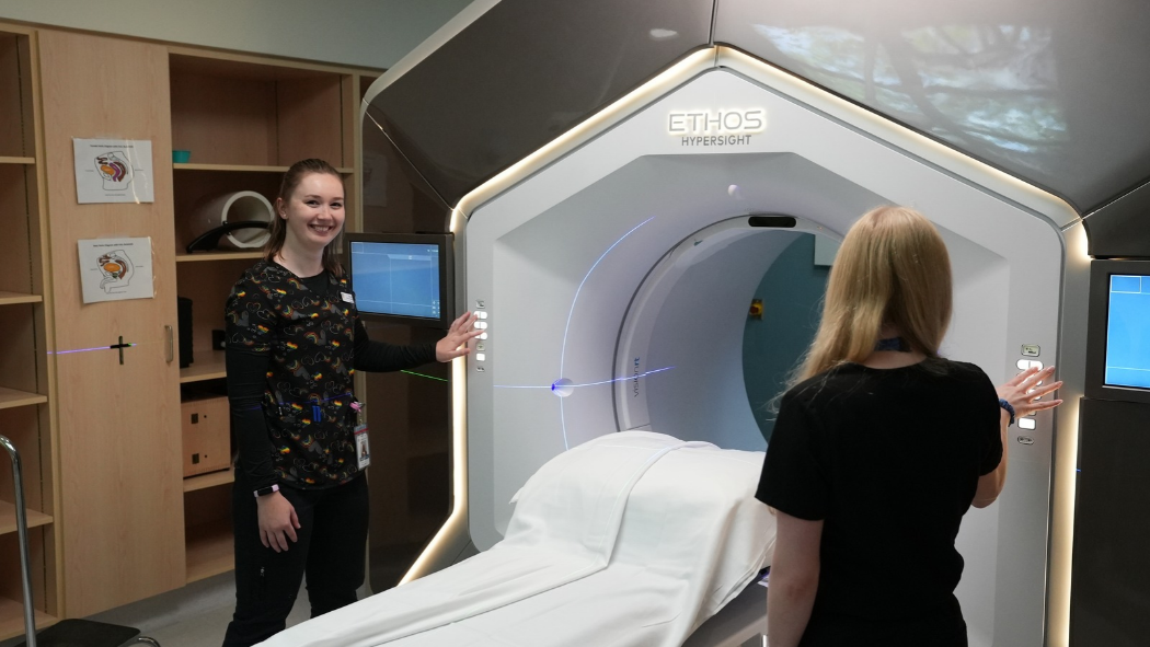 Photo from left: Meghan Koczwara and Christine Rossi, radiation therapists in the Verspeeten Family Cancer Centre preparing the Ethos linear accelerator (used to deliver radiation therapy) for a patient. 